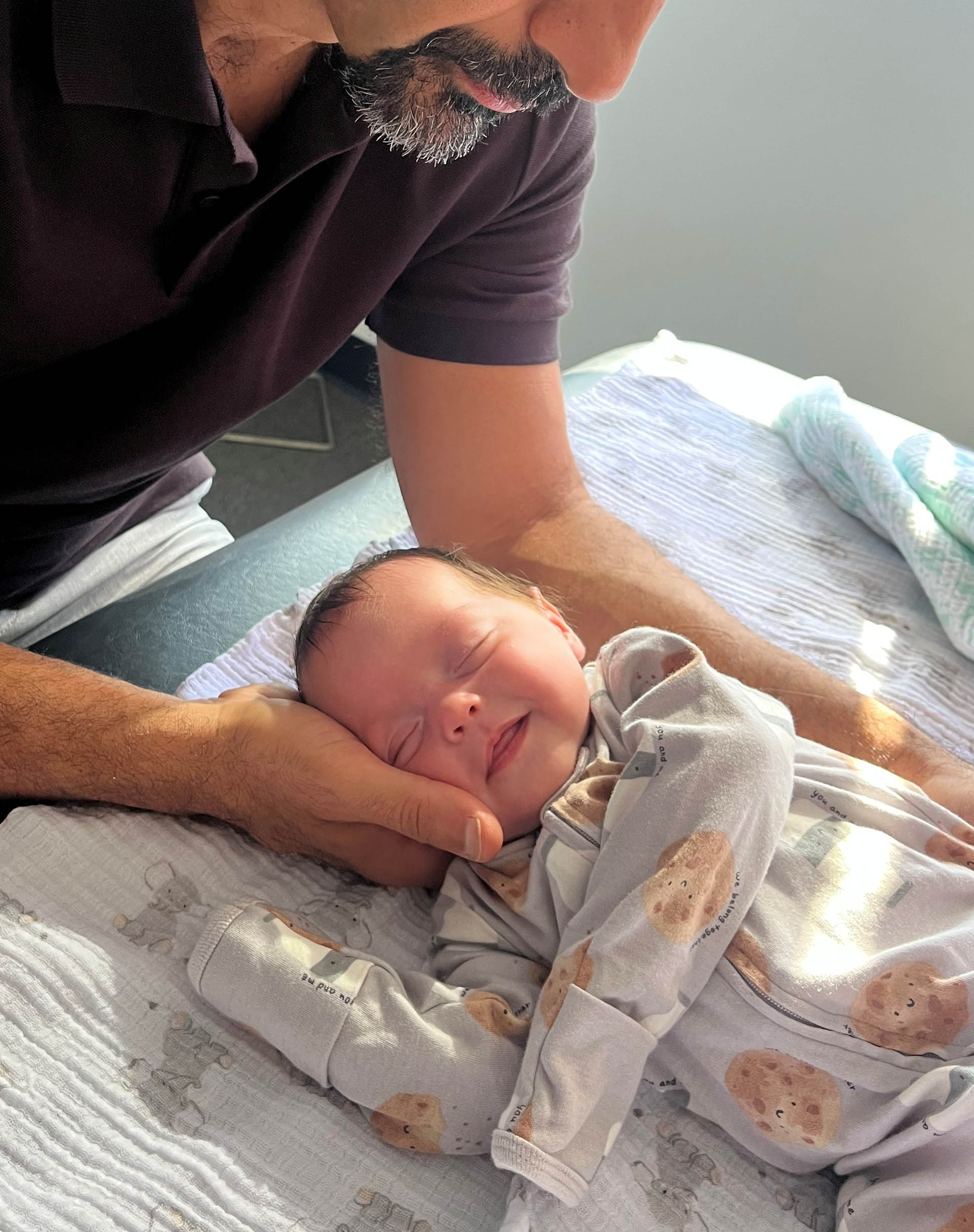 Osteopathic practitioner gently treating a newborn